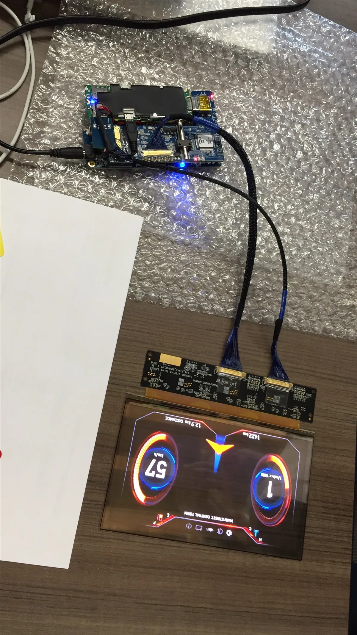 Transparent display prototype wired to a dev board on the bench
